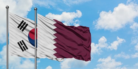 South Korea and Qatar flag waving in the wind against white cloudy blue sky together. Diplomacy concept, international relations.