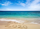Fototapeta Miasto - New Year 2020 is coming concept. Happy New Year 2020 replace 2019 concept on the sea beach