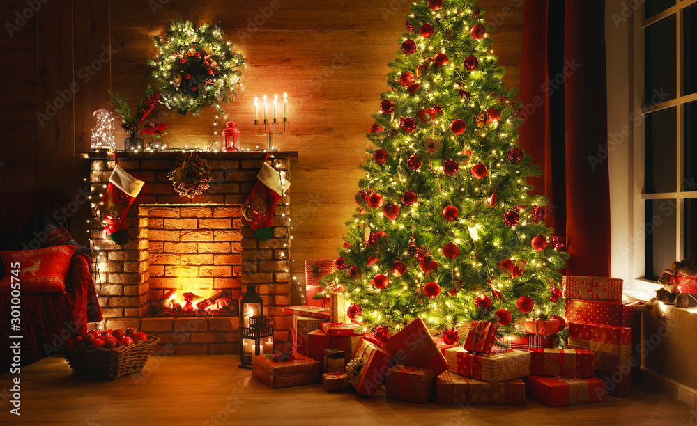 interior christmas. magic glowing tree, fireplace, gifts in  dark - obrazy, fototapety, plakaty 