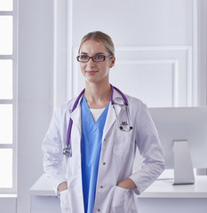 Wall Mural - Portrait of a happy smiling young doctor in headset in office