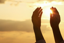 Hands Of Muslim Woman Praying Outdoors At Sunset