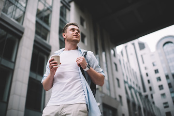 Relaxed casual man with coffee on street