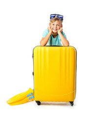 Poster - Cute little boy with suitcase on white background. Summer vacation concept