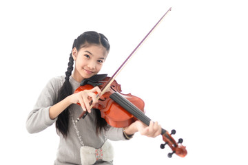 cute asian children holding violin on her shoulder and playing violin in her room, she feeling happy and smile in training time