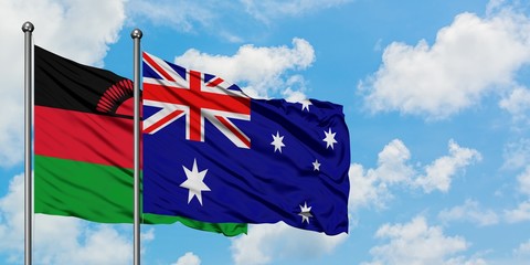 Malawi and Australia flag waving in the wind against white cloudy blue sky together. Diplomacy concept, international relations.