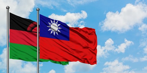 Malawi and Taiwan flag waving in the wind against white cloudy blue sky together. Diplomacy concept, international relations.