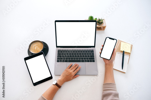 Fotografía Top view mockup image of hands holding a blank white screen mobile phone with la