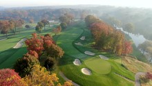 Slow Tracking Shot Above Golf Course Green, Sand Trap Hazards, Fall Leaves And River