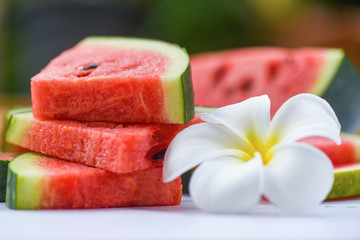 Fresh watermelon slice and white flower / watermelon tropical fruit on nature background