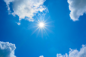 Wall Mural - blue sky with clouds and sun reflection.the sun shines bright in the daytime in summer.