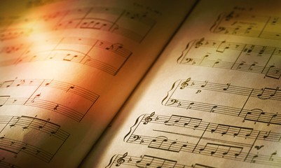 Sheets with music notes close-up on sunlight