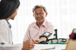 © ronnarong - Doctor measuring blood pressure of elderly man in medical office.