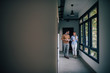 © bnenin - Business colleagues walking in the hall of the office building, copy space.