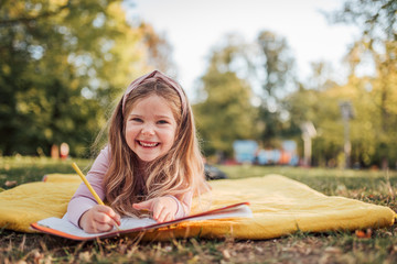 portrait of adorable little girl outdoors, copy space.