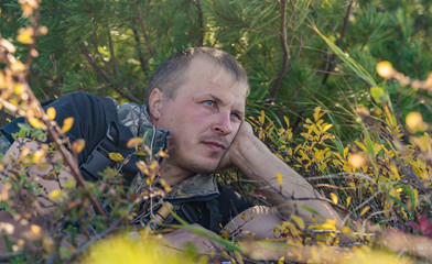 man with a gun watches prey