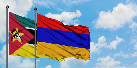 Mozambique and Armenia flag waving in the wind against white cloudy blue sky together. Diplomacy concept, international relations.