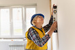 © Luca9257 - Woman Builder in the room of the house making repairs.