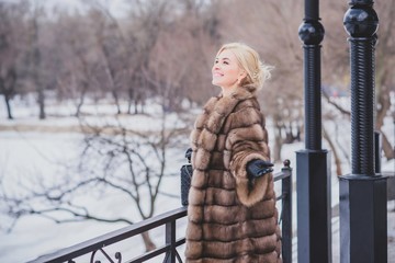 Vogue concept. Beautiful lady in holidays, modern woman wear fur coat look . Fashionable lady outdoors portrait