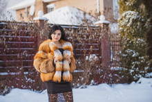 Vogue Concept. Beautiful Arabic Lady In Holidays, Modern Woman Wear Fur Coat Look . Fashionable Lady Outdoors Portrait