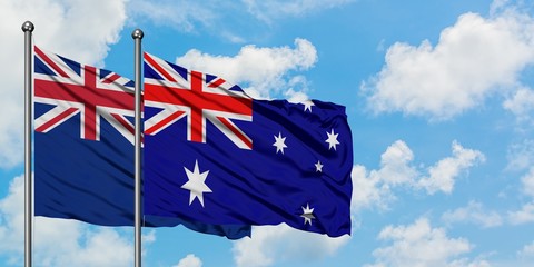 New Zealand and Australia flag waving in the wind against white cloudy blue sky together. Diplomacy concept, international relations.