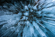 Natural Textural Background. Many Long Icicles Shot From Below. Sounds Like An Explosion. Blue Tint. Winter Background.