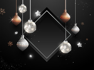 Sticker - Illustration of hanging baubles with stars and snowflakes decorated on black background with empty frame given for your message.