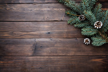 Christmas Tree With Cones On A Dark Wooden Background. Copy Space. Flat Lay.