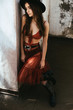 © LIGHTFIELD STUDIOS - beautiful fashionable woman posing in red skirt, bra and hat on roof
