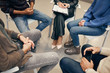 © AnnaStills - Close-up of people sitting on chair in the circle during therapy in the class