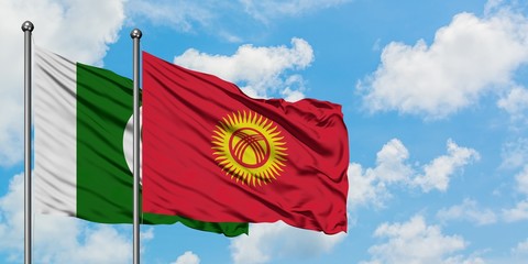 Pakistan and Kyrgyzstan flag waving in the wind against white cloudy blue sky together. Diplomacy concept, international relations.