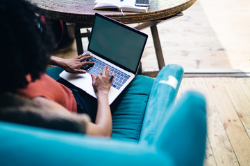 Wall Mural - Back view of female programmer working remotely with initializing database via laptop application with blank screen for advertising text, skilled woman searching business website on netbook