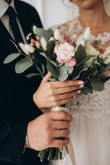 wedding bouquet in the hands of the bride and groom
