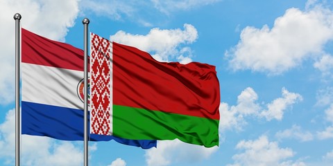 Paraguay and Belarus flag waving in the wind against white cloudy blue sky together. Diplomacy concept, international relations.
