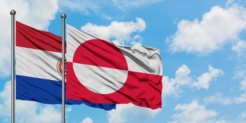 Paraguay and Greenland flag waving in the wind against white cloudy blue sky together. Diplomacy concept, international relations.