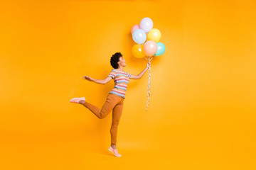 Poster - Full length body size view of nice attractive cheerful cheery wavy-haired girl holding in hand air balls having fun isolated over bright vivid shine vibrant yellow color background