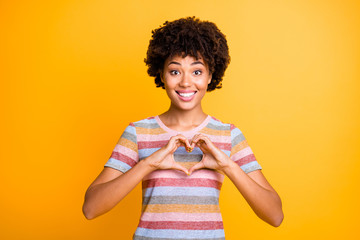 Poster - Close-up portrait of her she nice attractive lovely cheerful cheery funny girlish wavy-haired girl showing heart gesture isolated over bright vivid shine vibrant yellow color background