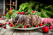 Homemade Christmas Baking. Dark Chocolate Gingerbread Christmas Bundt Cake With Powdered Sugar, Fresh Cranberries And Rosemary, With Xmas Tree Decoration