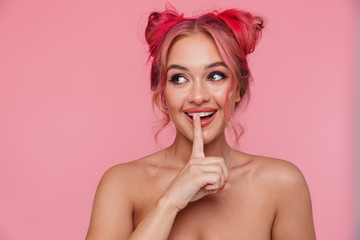 Wall Mural - Portrait of shirtless young woman smiling and keeping finger at her mouth