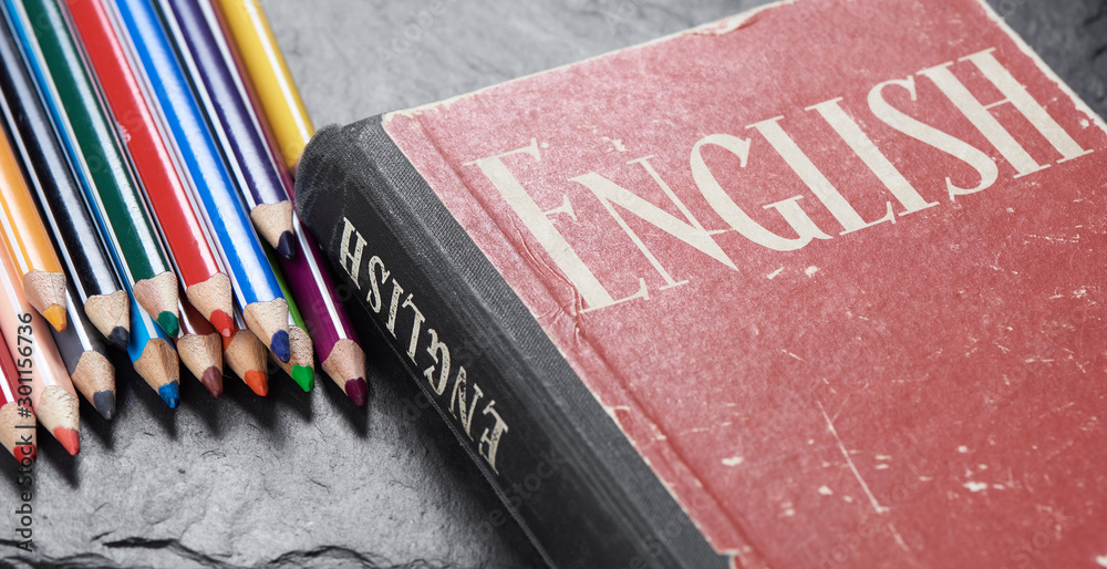 Learning english concept. Dictionary with pencils - obrazy, fototapety, plakaty 