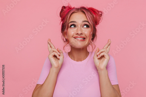 Portrait Of Young Woman Keeping Fingers Crossed And Wishing Good