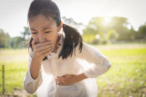 Cuadros en Lienzo Asian beautiful child girl covered her mouth about to throw up,vomit,puke retch