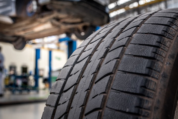 Car maintenance and service center. Vehicle tire repair and replacement equipment. Seasonal tire change - Close-up of old tires