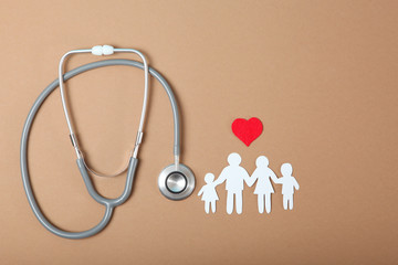  stethoscope and heart on a colored background top view. Family medicine