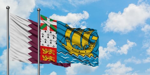 Qatar and Saint Pierre And Miquelon flag waving in the wind against white cloudy blue sky together. Diplomacy concept, international relations.