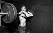 © Srdjan - Young strong fit muscular sweaty man with big muscles doing barbell weight lifting cross training workout in the gym dark image real people black and white