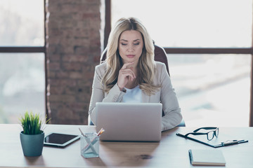 Photo of amazing blond business lady resourceful person looking seriously notebook on table sitting boss chair formalwear blazer in modern office