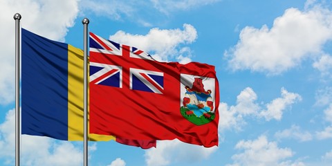 Romania and Bermuda flag waving in the wind against white cloudy blue sky together. Diplomacy concept, international relations.