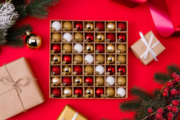Wall Mural - Top above high angle view photo of toys baubles in box with wrapped gifts branch tinsel isolated vivid red color background