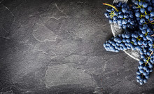 FInest Home Bunch Of Grapes On Dark Stone Table On Silver Plate Top View. Fresh Grape On Black Background, Wide Banner Or Panorama For Copy Space.
