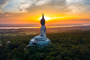 Top view Aerial photo from flying drone.Big Buddha Wat Phu Manorom Mukdahan Thailand.Buddha on the mountain.